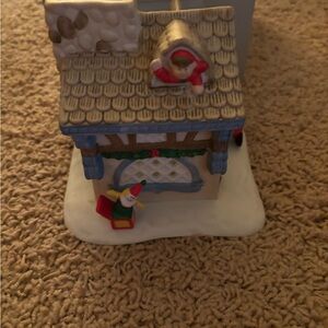 Charming Holiday House Figurine with Santa and Snowman lights with a candle